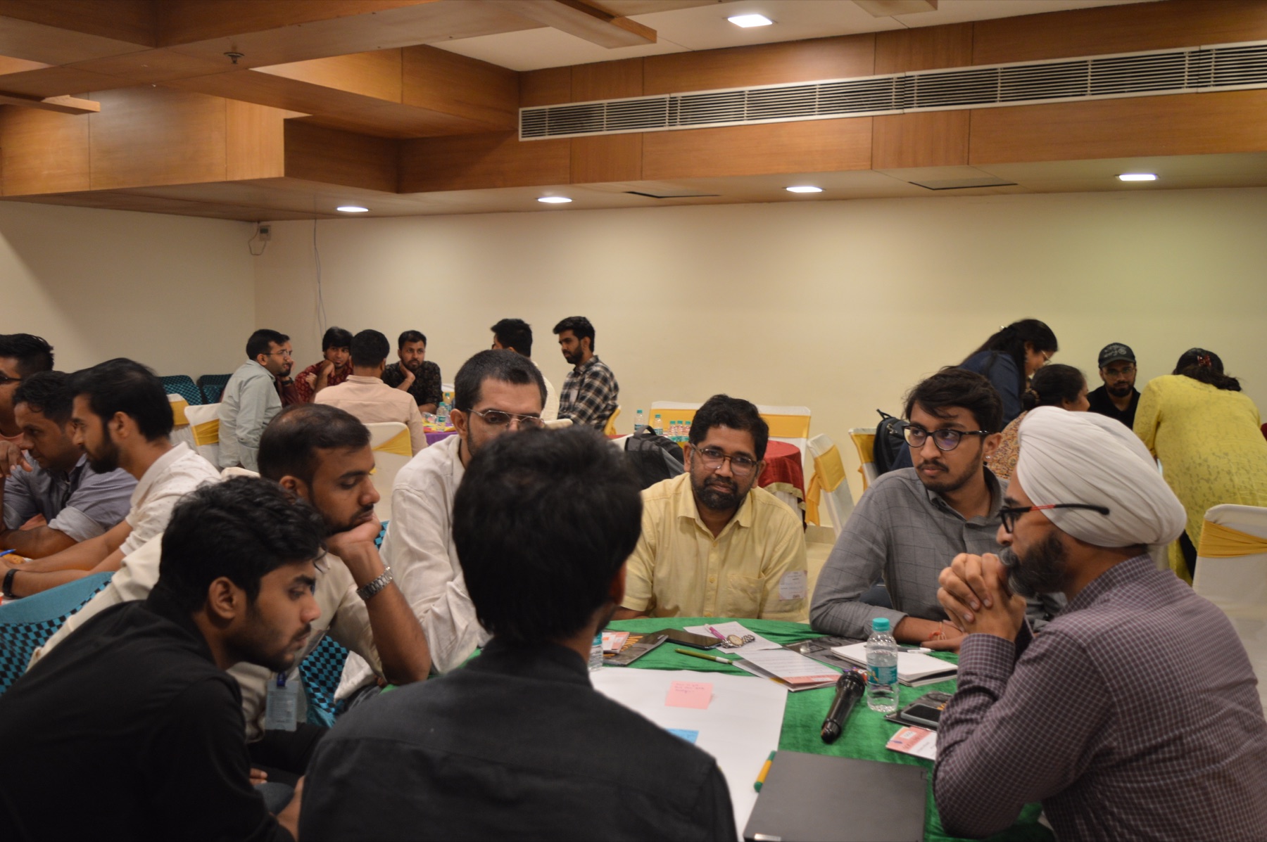 Social-impact practitioners working together around a table at an EdZola workshop