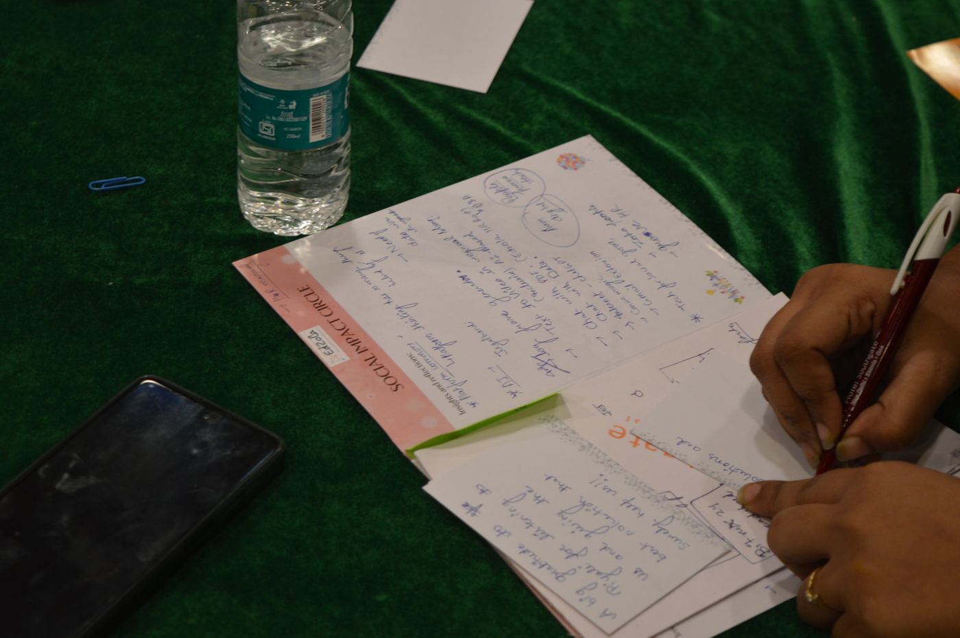 A participant writing notes during a session